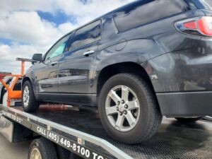 Black SUV on flat bed for OK Towing Service in Oklahoma City